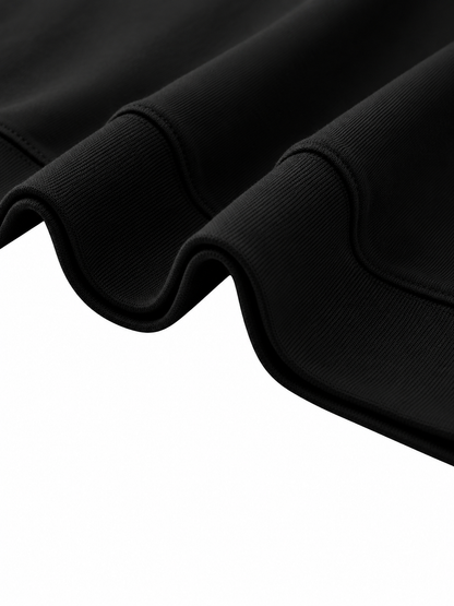 Close-up of the ribbed hem on the Steelvora black oversized crewneck sweatshirt, showing premium cotton-blend fabric and construction details.