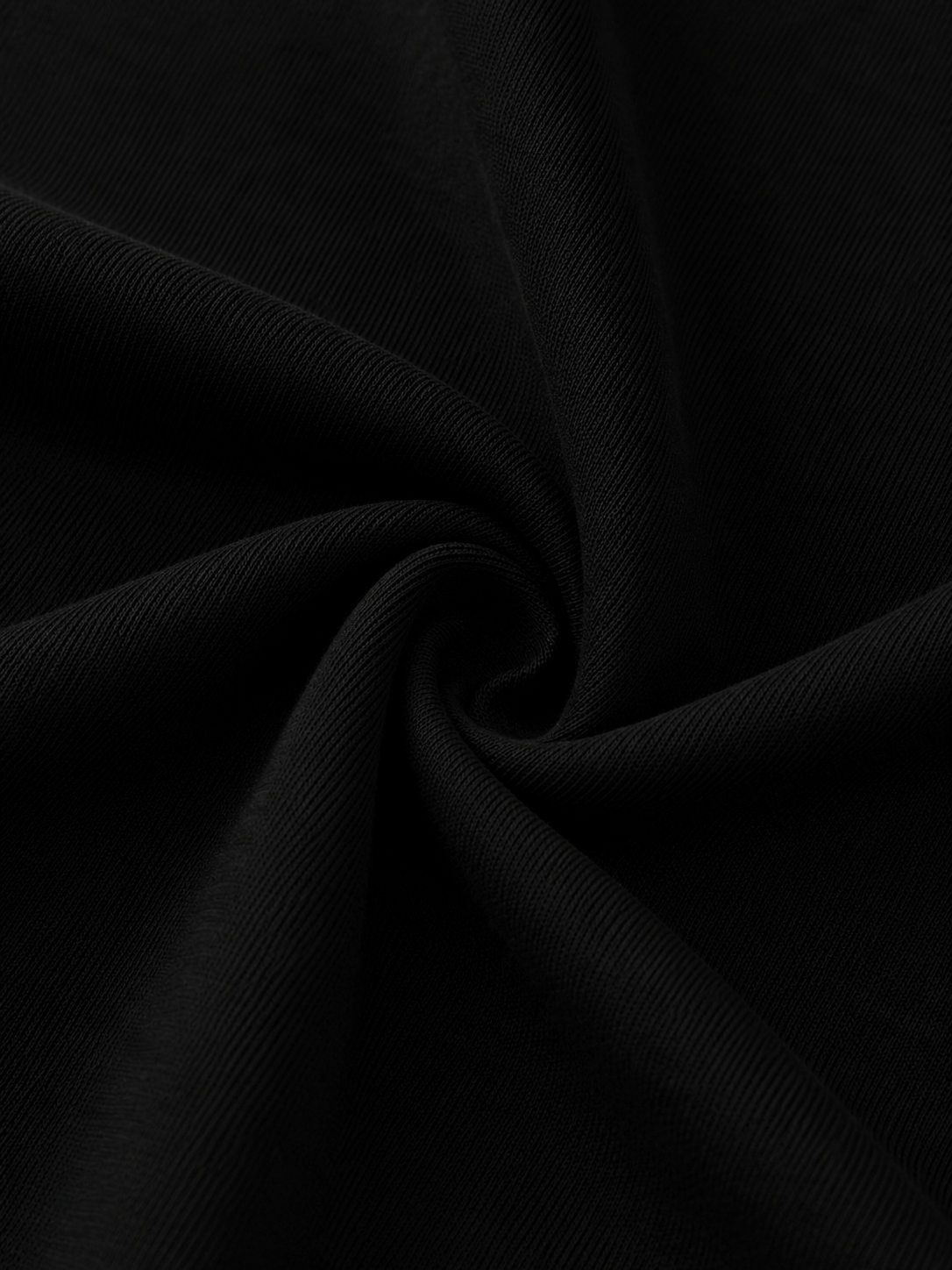 Close-up of the black Steelvora SUNDOWN oversized crewneck sweatshirt fabric showing the soft cotton-blend texture in a swirl fold.