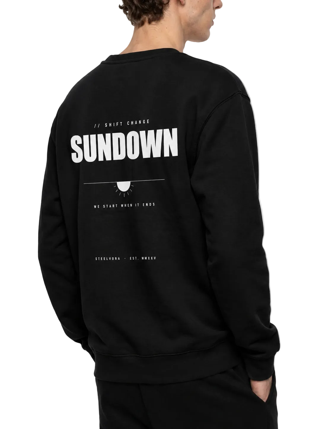 Back angled view of the Steelvora SUNDOWN oversized black crewneck sweatshirt featuring the large white SUNDOWN graphic print.