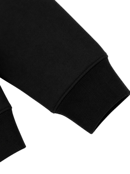 Close-up of the ribbed cuff on the Steelvora SUNDOWN oversized black crewneck sweatshirt.