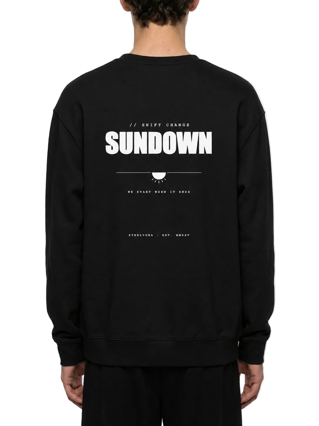 Back view of a model wearing the Steelvora SUNDOWN oversized black crewneck sweatshirt featuring a bold white SUNDOWN graphic print.