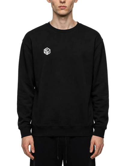 Front view of a model wearing the Steelvora SUNDOWN oversized black crewneck sweatshirt featuring a white SV chest logo.